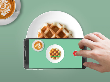 Taking food photography with smartphone on waffle.の写真素材