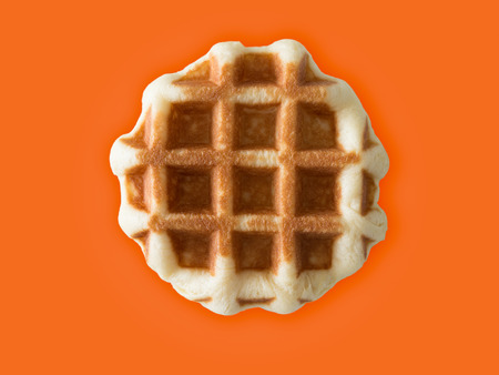 Honey brown waffle isolated on colour background.の写真素材