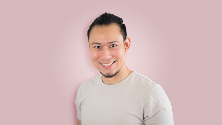 Happy Asian hipster man with man bun hair style.の写真素材
