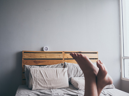 White simple clock on loft woden bed in the morning.の写真素材