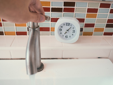 Simple white clock in the bathroom. Concept of life routine.の写真素材