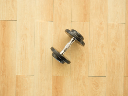 One dumbbell left alone on the floor in the gym.の写真素材