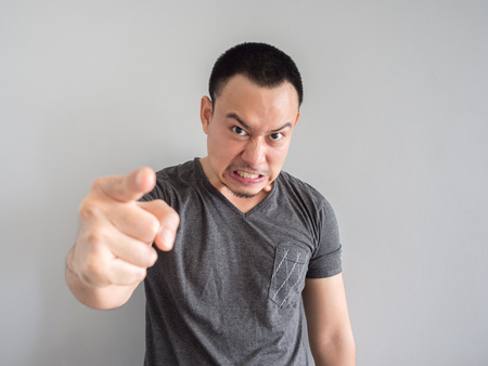 Angry asian man portrait with funny mad face.の写真素材
