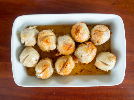 Dish of Thai meatballs on spicy and sweet sauce.の写真素材