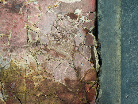 Cracked and damaged cements footpath.