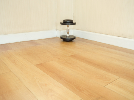 One dumbbell left alone on the floor in the gym.の写真素材
