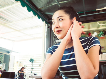 Asian woman in drink and relax in coffee cafe.の写真素材