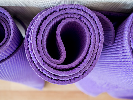 Rolls of yoga mats left in the yoga gym room.の写真素材