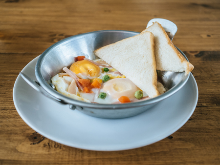 Small breakfast set of fried egg and breads.の写真素材