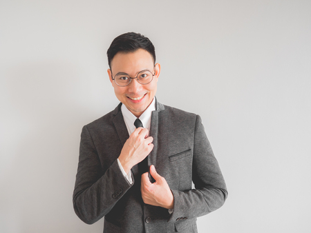 Happy Asian boss manager business man wears black suit in relax pose.の写真素材