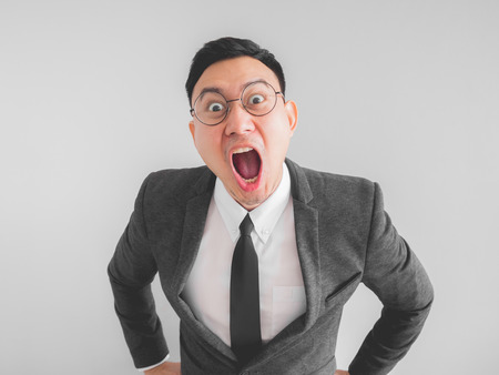 Angry Asian boss manager businessman in black suite.の写真素材