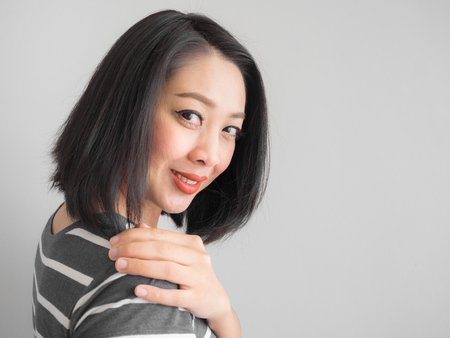 Smile Asian woman making interest look at the camera.の写真素材