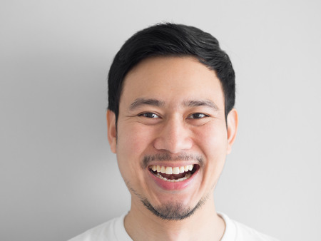 Head shot of laughing face Asian man.