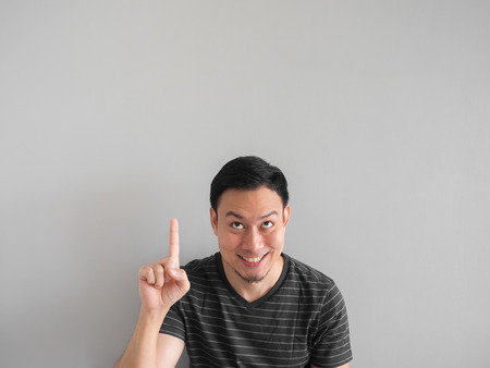 Happy Asian man point on empty space.の写真素材