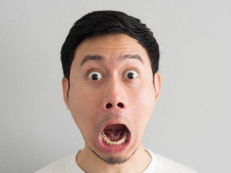 Shock face of Asian man head shot.の写真素材