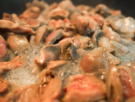 Close up of Asian food cooked chicken hearts fried in pan.の写真素材