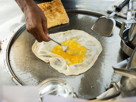 Thai crispy roti street food cart vendor.の写真素材