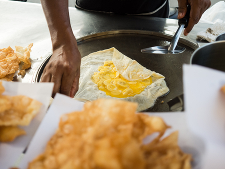 Thai crispy roti street food cart vendor.の写真素材