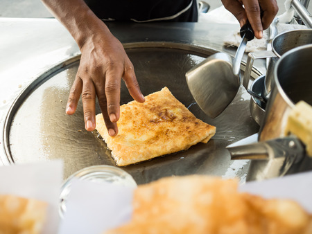 Thai crispy roti street food cart vendor.の写真素材