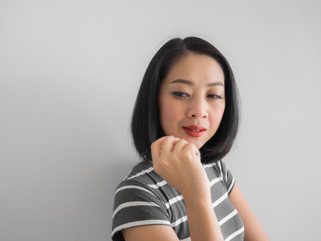 Smile Asian woman thinking and planning for solution.の写真素材