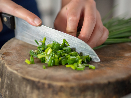Hand cut Scallions on wooden cutting board.の写真素材