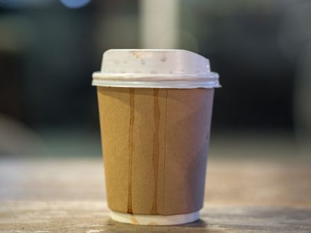 Paper cup of hot coffee in the cafe.の写真素材