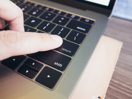 Close up of return button of laptop. Concept of making dicision.