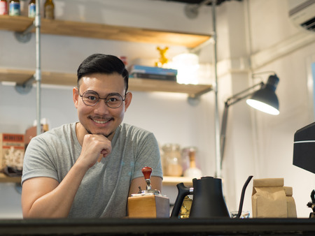 Asian man being barista and own a small coffee shop.の写真素材