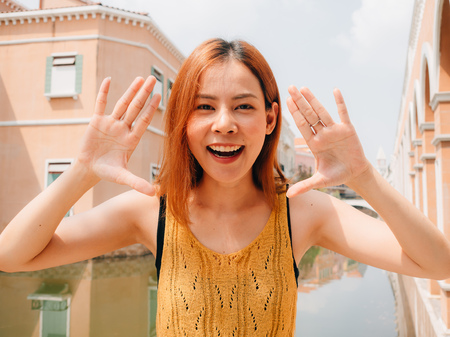 Asian woman tourist taking photo with funny pose on travel trip.の写真素材