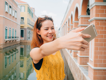 Asian woman tourist is taking selfie photo from the smartphone.の写真素材