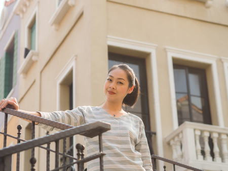 ASian woman standing outdoor for sightseeing and relax in a warm day.の写真素材