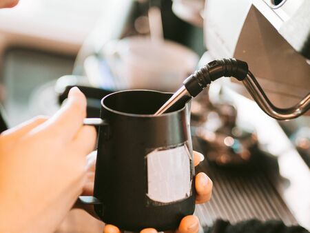 In process of barista making a cup of coffee for customer in the cafe.の写真素材