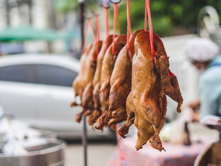 Rosted brown duck shop in local street market in Thailand.の写真素材