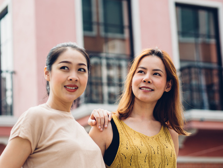 Two Asian best friends women tourists travel in European town.の写真素材