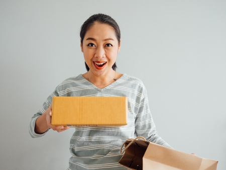 Asian woman is feeling happy and surprised with the online purchursed product and survice. Concept...