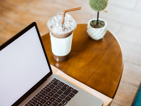 White empty screen laptop on table in the coffee cafe.の写真素材