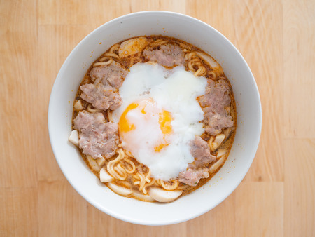 Top view of instant noodle with soft boiled egg and pork. Concept of cheap meal.の写真素材