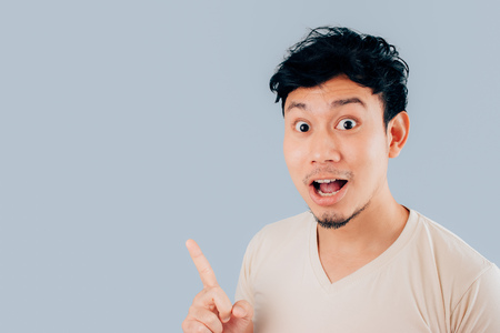 Wow and surprised face of Asian man on isolated background.の写真素材