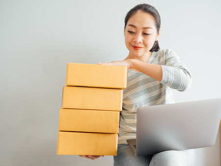 Concept of Asian woman happy with her online business sale.