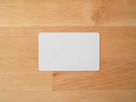 White empty mockup credit card on wooden table.の写真素材