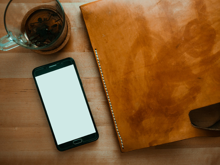 Top view flat lay of leather bag smartphone and tea cup.の写真素材