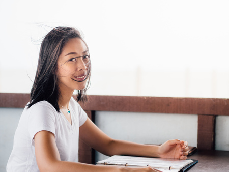 Asian woman reading the local restaurant menu.の写真素材
