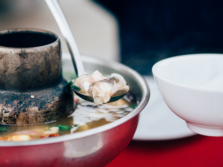 Thai clear soup spicy tom yum seafood in the hot pot.の写真素材