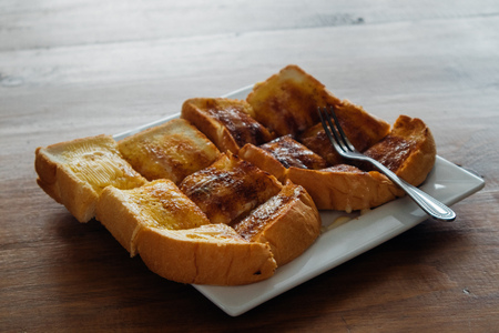 Butter sweetened condensed milk bread on white dish.