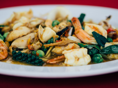 Thai Fried stir spicy sea food in white dish.の写真素材