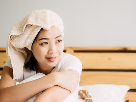 Close up of Asian woman relax on her bed after bath.の写真素材
