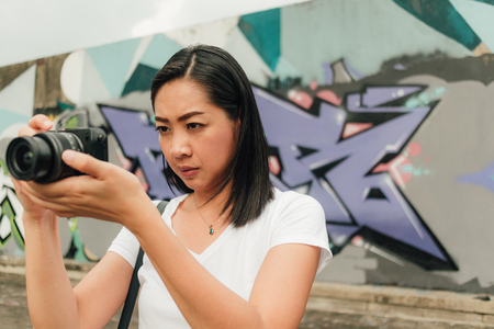 Asian woman enjoy taking photo of an unknown abandoned building.の写真素材