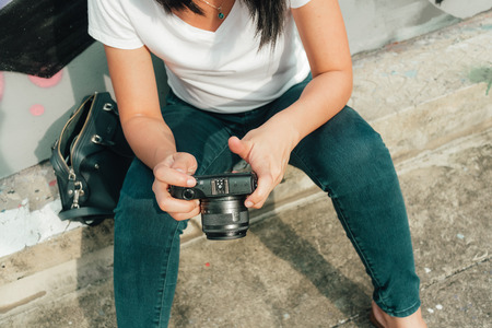 Asian woman enjoy taking photo of an unknown abandoned building.