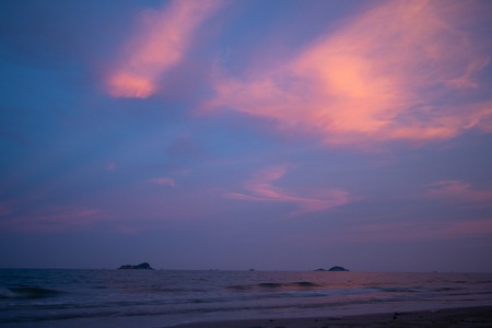 Vivid purple sky with light beam from sunset on the beach.の写真素材