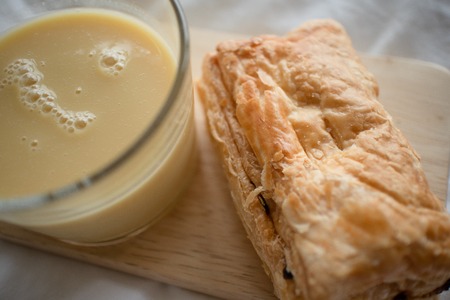 Corn milk with stuffed puff pastry served on bed.